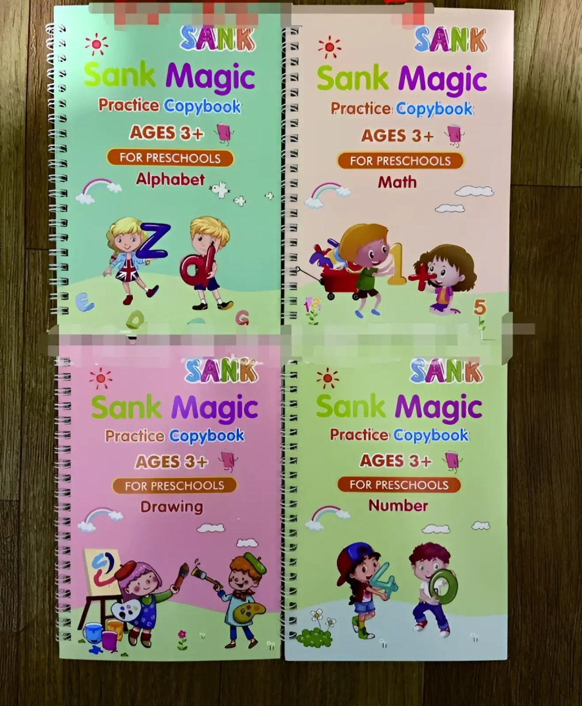 Four colorful spiral-bound sank magic practice copybooks for preschoolers with alphabet math drawing and number themes
