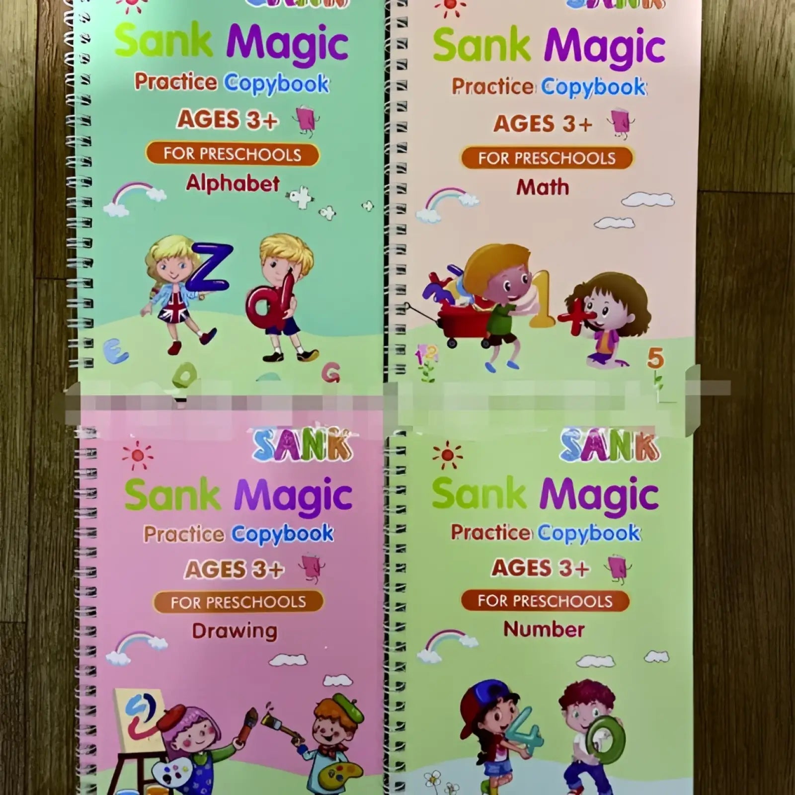 Four colorful spiral-bound sank magic practice copybooks for preschoolers with vibrant cartoon learning themes