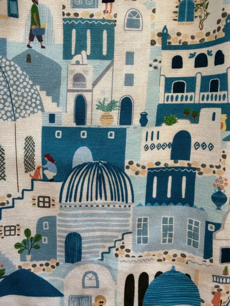 Blue and white illustrated cotton fabric on santorini retro sleeveless dress with peter pan collar featuring mediterranean town design