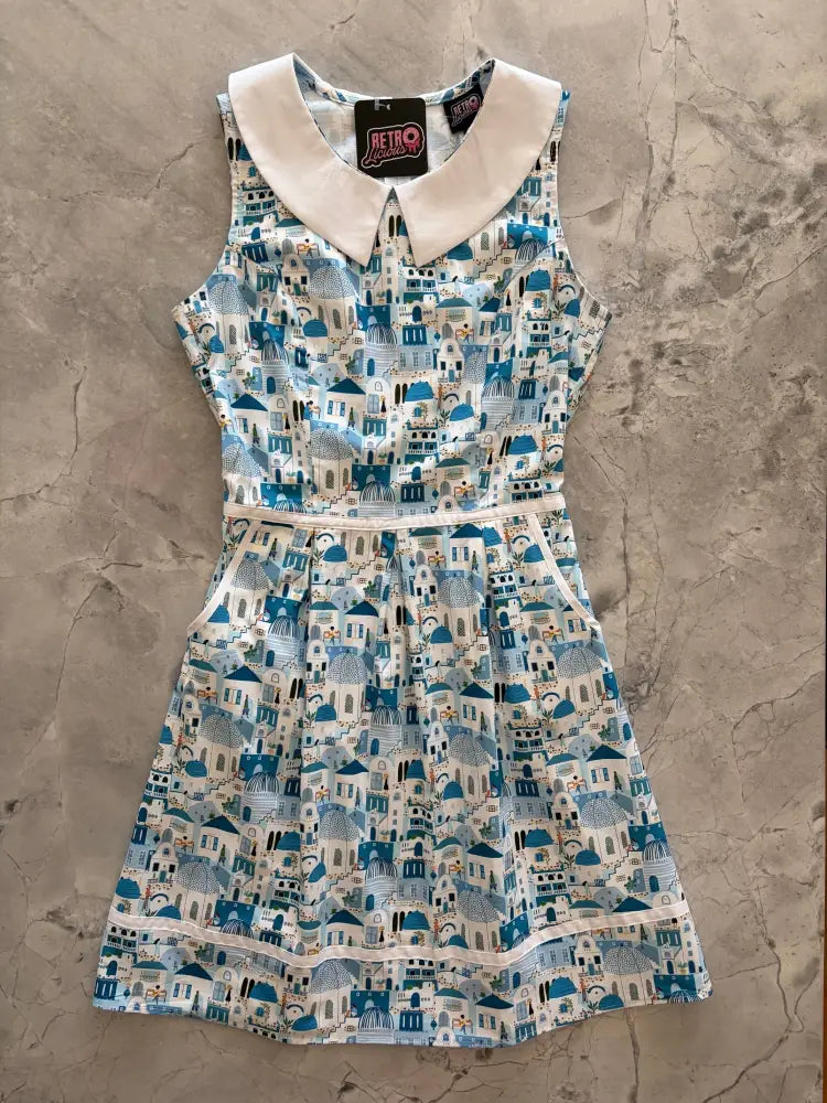 Santorini retro cotton sleeveless dress with white peter pan collar and blue building pattern, fitted waistband and pleated skirt