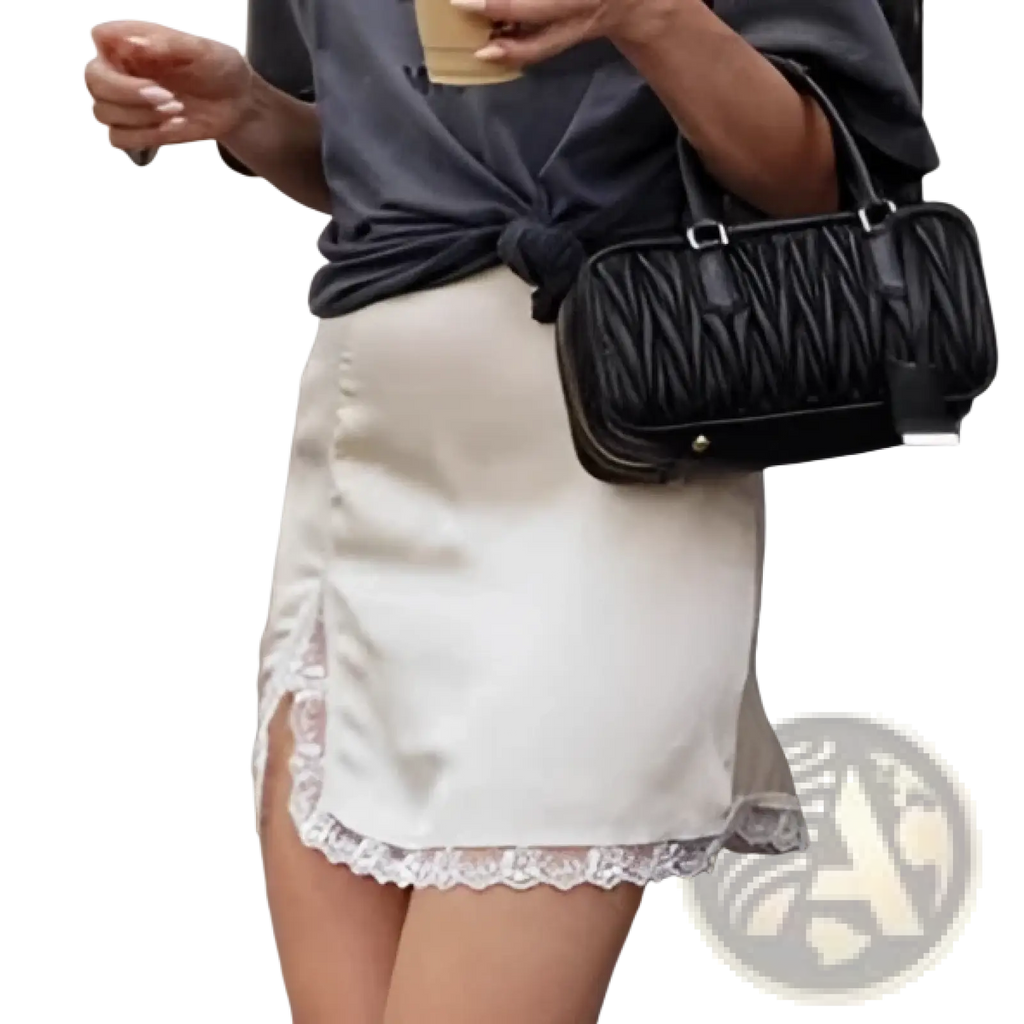 Black quilted handbag with structured rectangular shape and silver-tone hardware paired with satin lace a-line mini skirt
