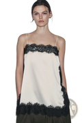 Cream-colored satin camisole top with black lace trim along the neckline and hem for elegant wear
