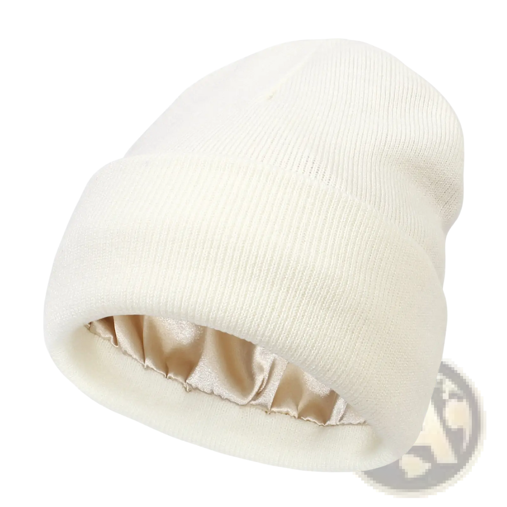 Cream-colored knit beanie with satin-lined interior designed for warmth as a winter hat