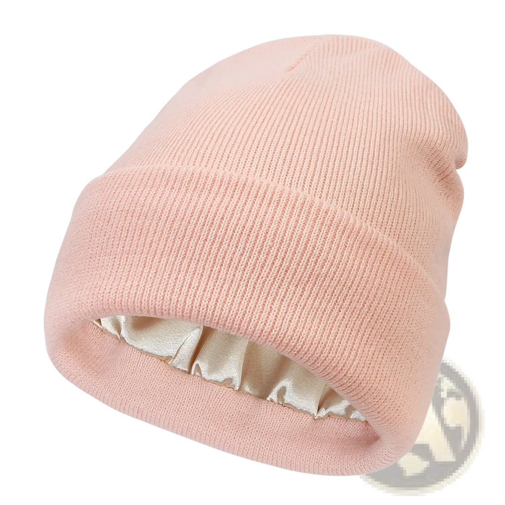 A soft pink ribbed knit beanie with satin lining designed as a warm winter hat