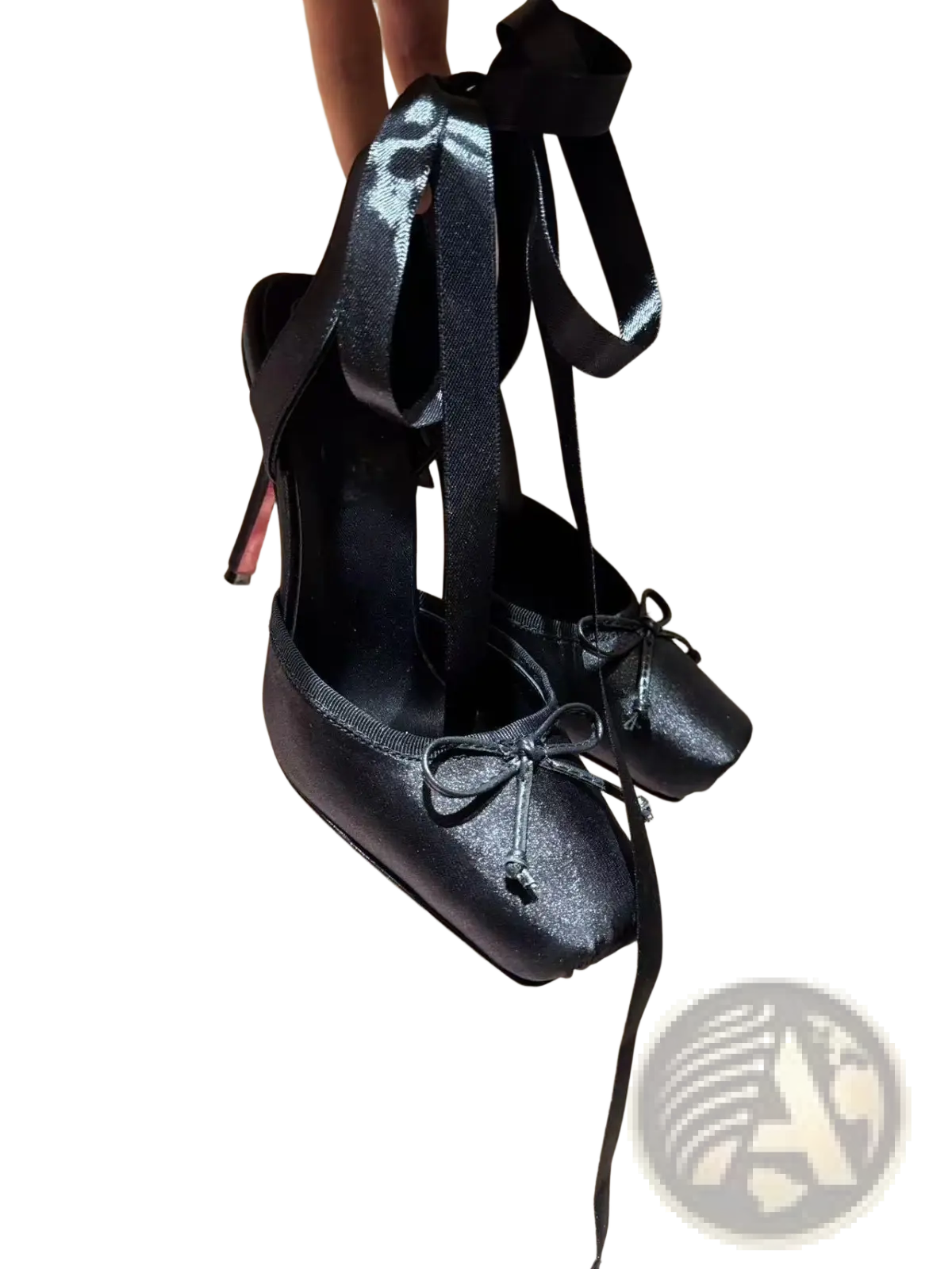 Black patent leather ballet flats with satin ribbon ties and a red high heel with leather sole shown from the back
