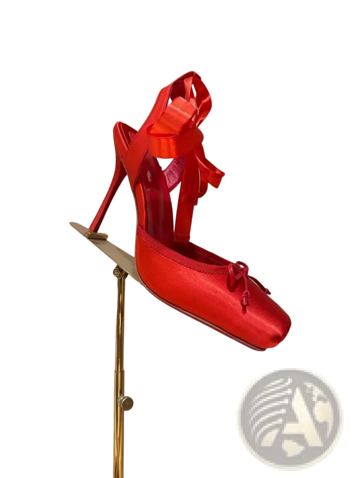 A vibrant red satin high heel ballet flat with leather sole and bow details on the ankle strap and toe