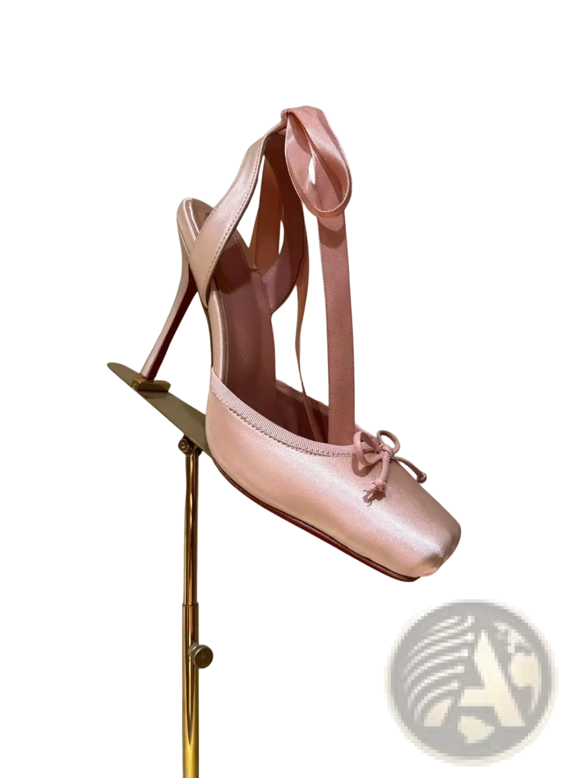 A delicate pink satin ballet flat with slender high heel and ribbon ties featuring a leather sole