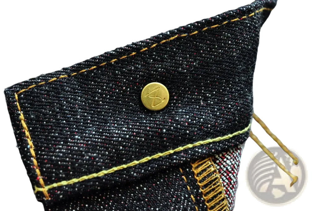 Dark indigo denim jacket with gold toned buttons and yellow stitching paired with saucezhan fire selvedge tapered jeans