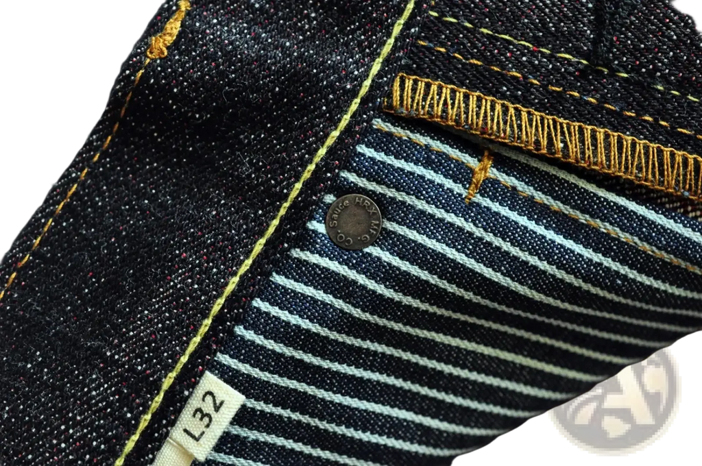 Dark indigo saucezhan fire selvedge tapered raw denim jeans with white pinstripes and yellow stitching details