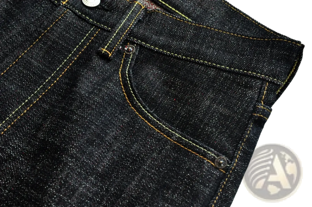 Dark indigo saucezhan fire selvedge tapered raw denim jeans with yellow stitching and silver metal buttons
