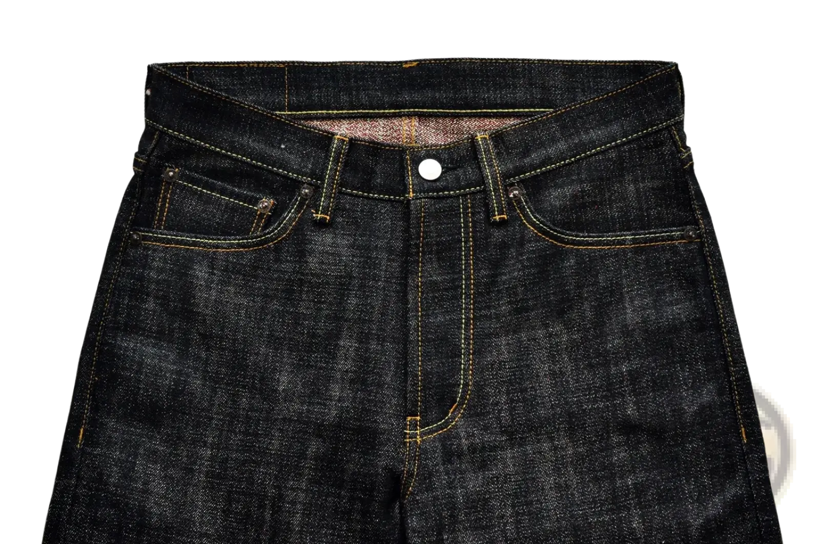 Dark indigo Saucezhan Fire Selvedge tapered raw denim jeans with yellow stitching and white button closure