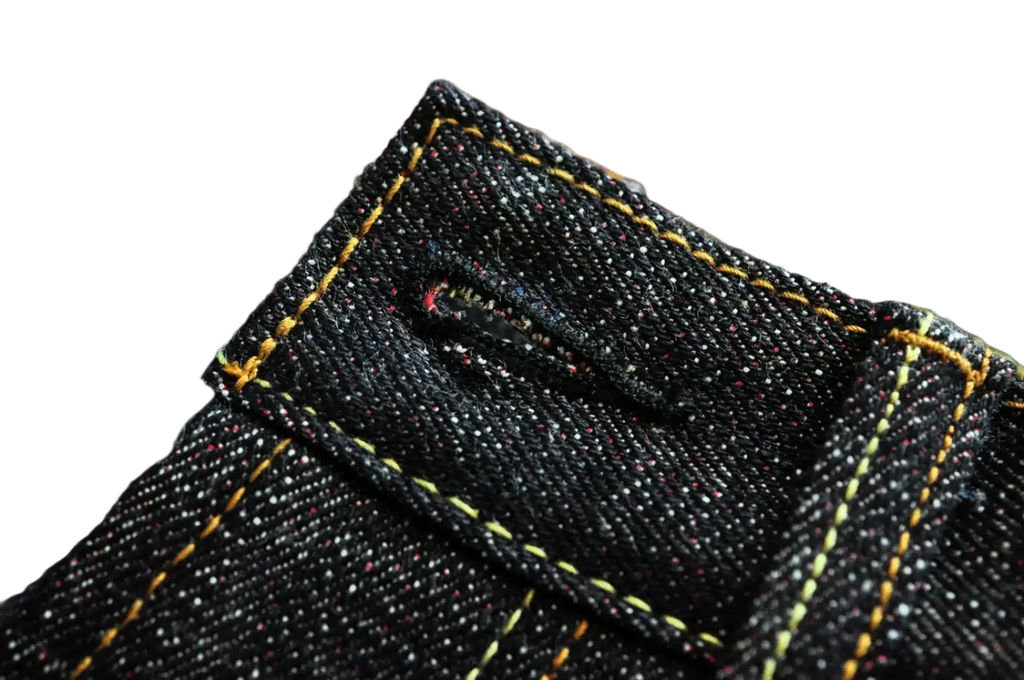 Sauzezhan fire selvedge tapered raw denim jeans in dark indigo with yellow stitching and subtle speckled texture