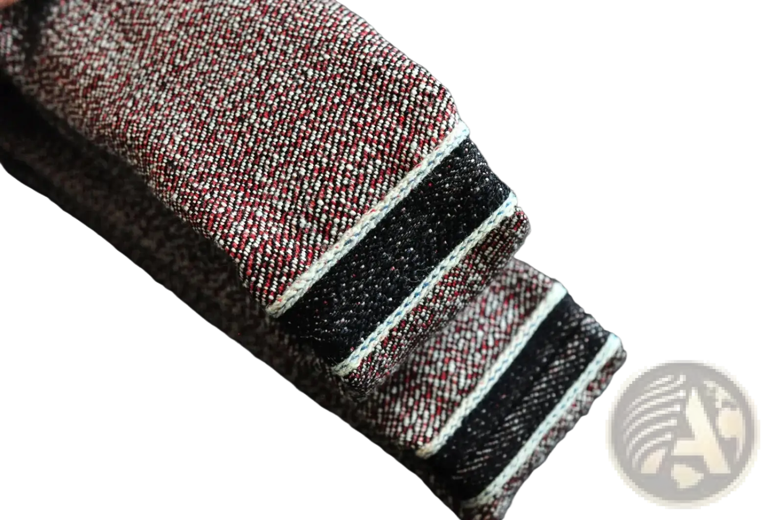 Saucezhan Fire Selvedge tapered raw denim jeans in dark denim with red and white woven cuff and black contrast stitching