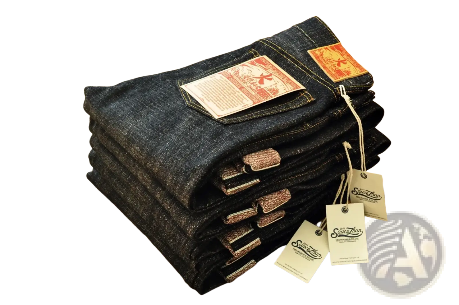 Stack of dark indigo saucezhan fire selvedge tapered raw denim jeans with orange and white brand tags visible