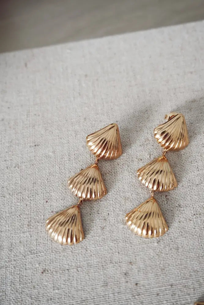 Gold layered scallop shell drop earrings featuring a gold-toned, three-piece layered design