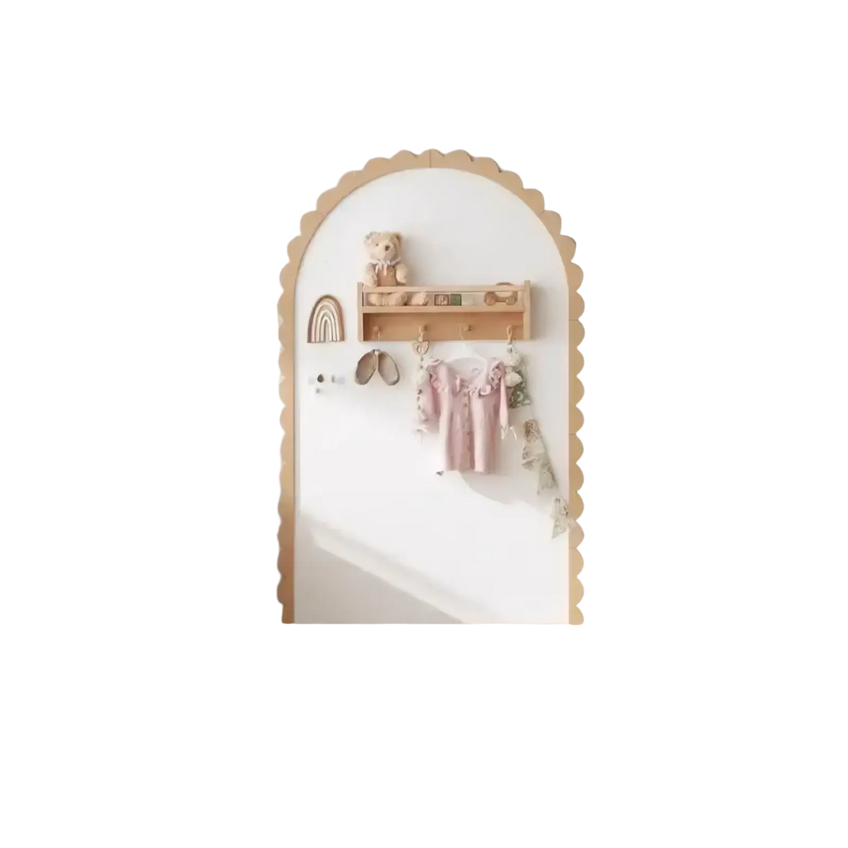 A white arched door with scalloped wooden frame featuring a small shelf holding a teddy bear and decorative items