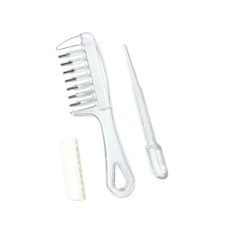 Clear plastic scalp massage applicator brush with metal-tipped teeth and matching dropper for essential oil use