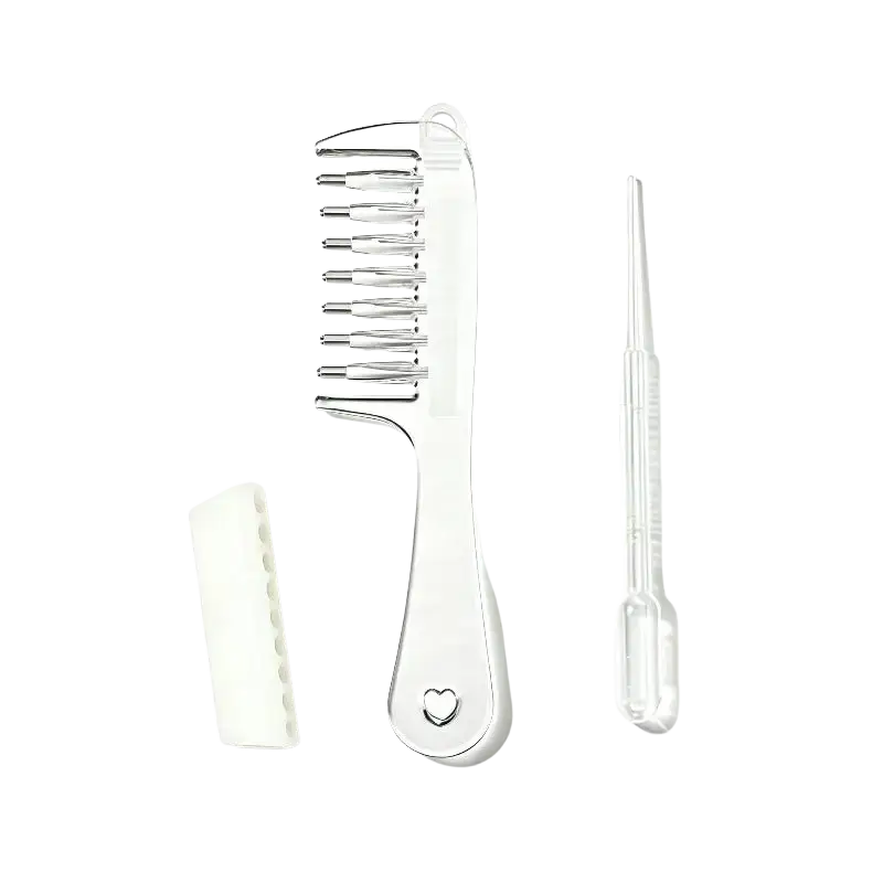 Clear plastic scalp massage applicator brush with metallic teeth heart cutout white case and essential oil dropper