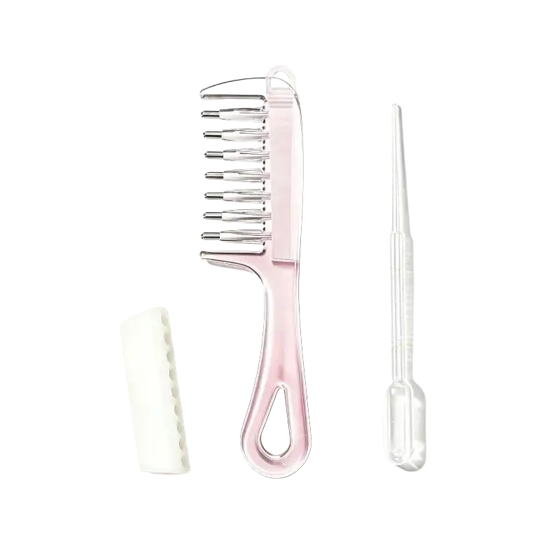 Pink plastic scalp massage applicator brush with metallic teeth, white brush, and clear essential oil dropper