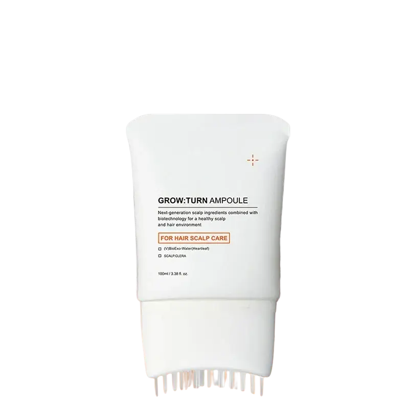 White tube of grow:turn scalp treatment serum with built-in bristle brush for targeted scalp care application