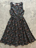 Black sleeveless 1950s cotton midi dress with colorful chalkboard science print and pockets
