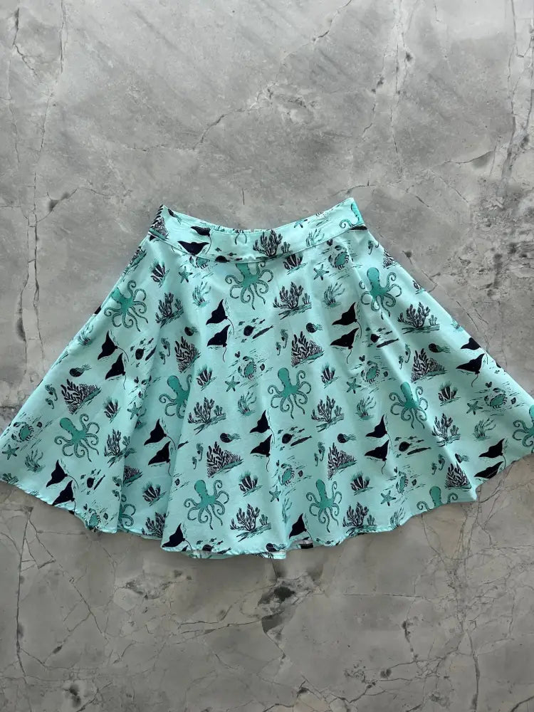Sea skater A-line cotton skirt in mint green with teal octopuses black sharks and coral nautical print patterns