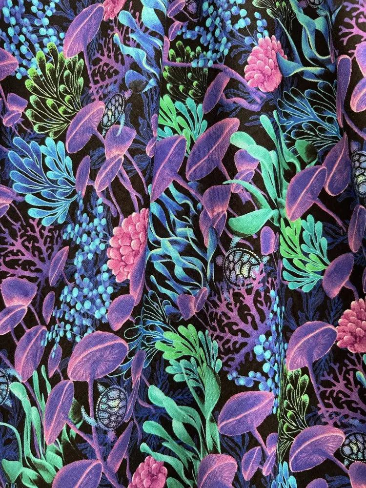 Sea vintage neon tropical cotton a-line dress featuring vibrant neon coral and turtle patterns on a black background