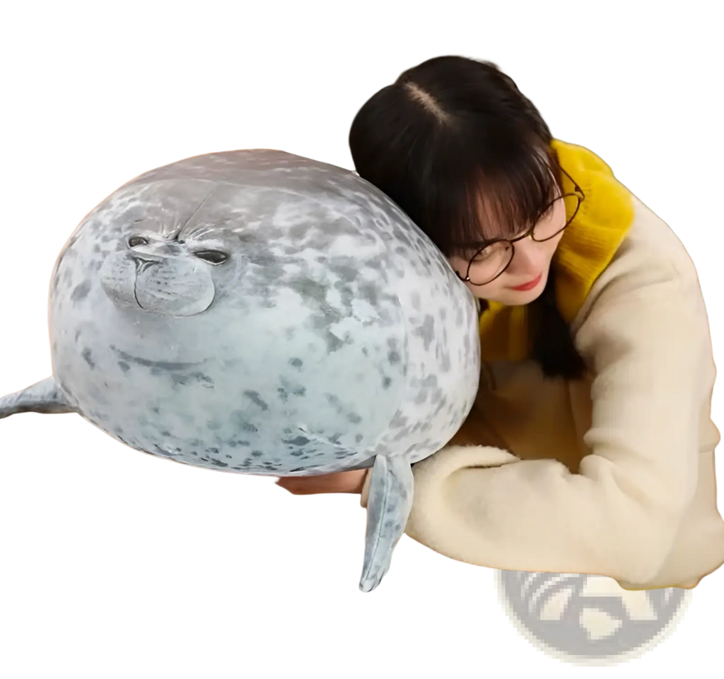 A large spotted seal plush toy with a soft gray and white speckled pattern for use as an animal pillow