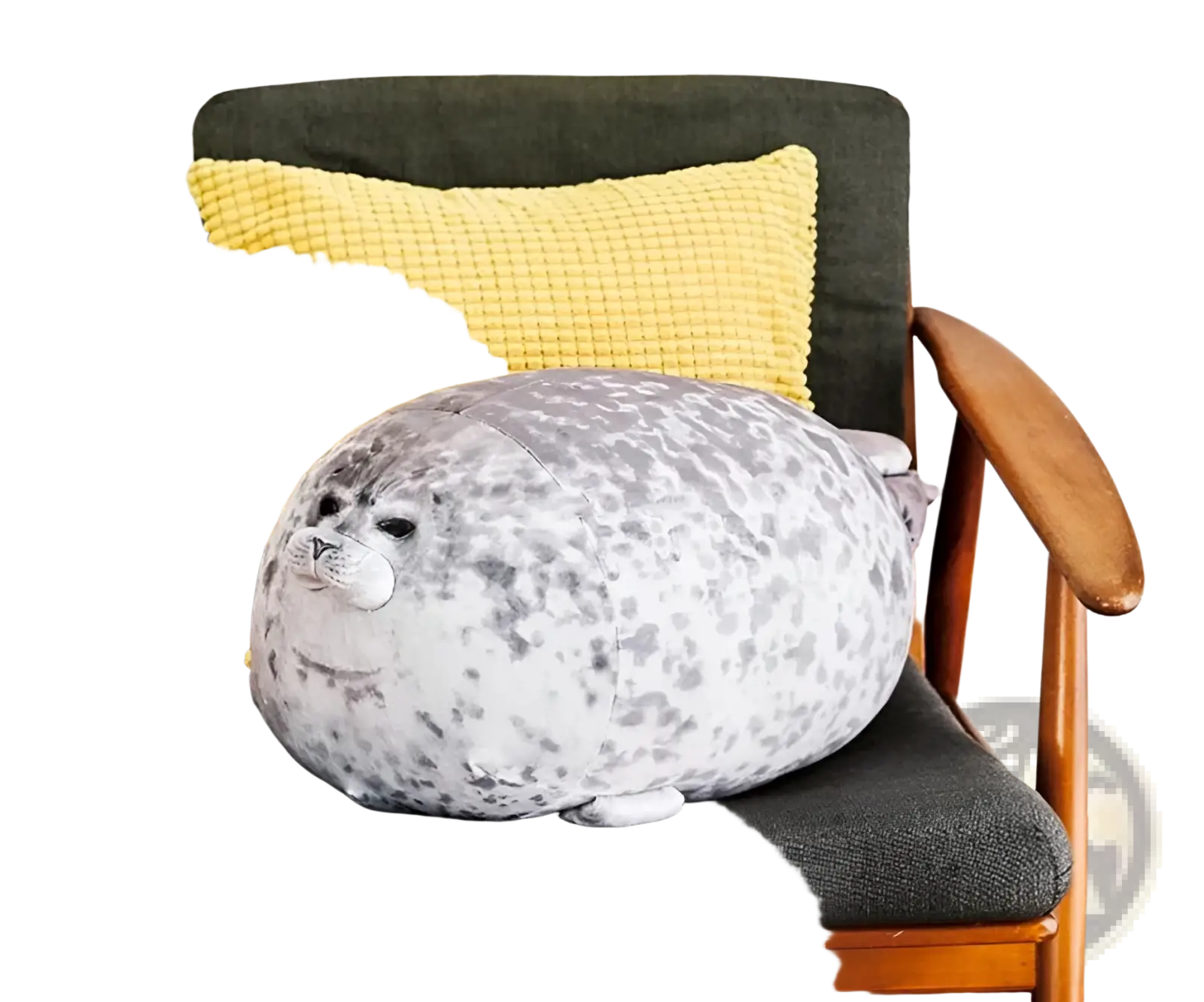A large spotted seal plush toy pillow in gray and white speckled pattern on a dark green armchair