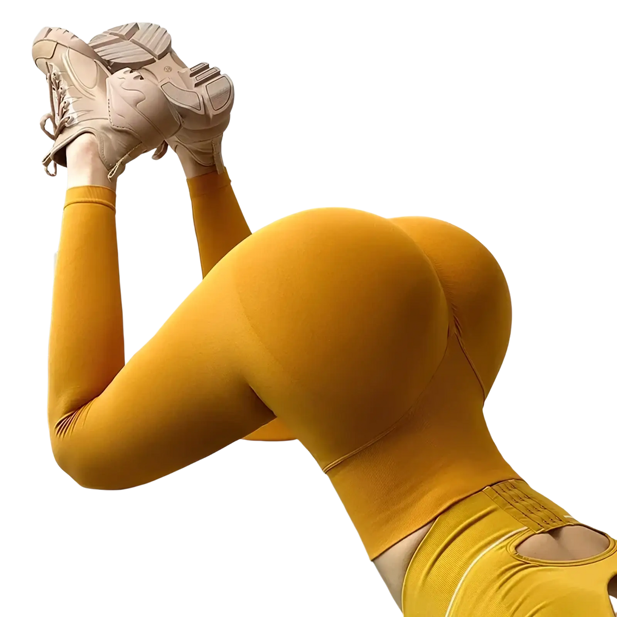 A pair of seamless high waist fitness leggings in mustard yellow with side cutouts and a form-fitting design