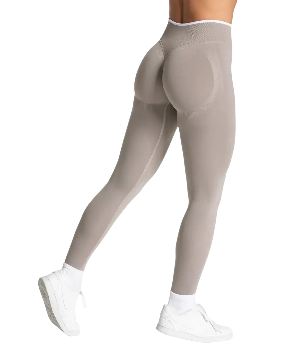 A pair of seamless high waist taupe leggings with smooth form-fitting fabric and subtle seam detailing