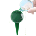 Green plastic seed sower with circular top and pointed stake handheld plant seeder for precise seed planting
