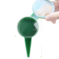 Green plastic seed sower with circular top and pointed stake handheld plant seeder for precise seed planting
