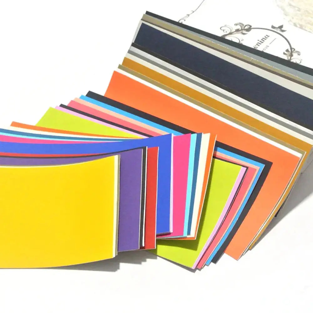 A vibrant collection of colorful paper sheets fanned out featuring bold hues and stripes for creative projects