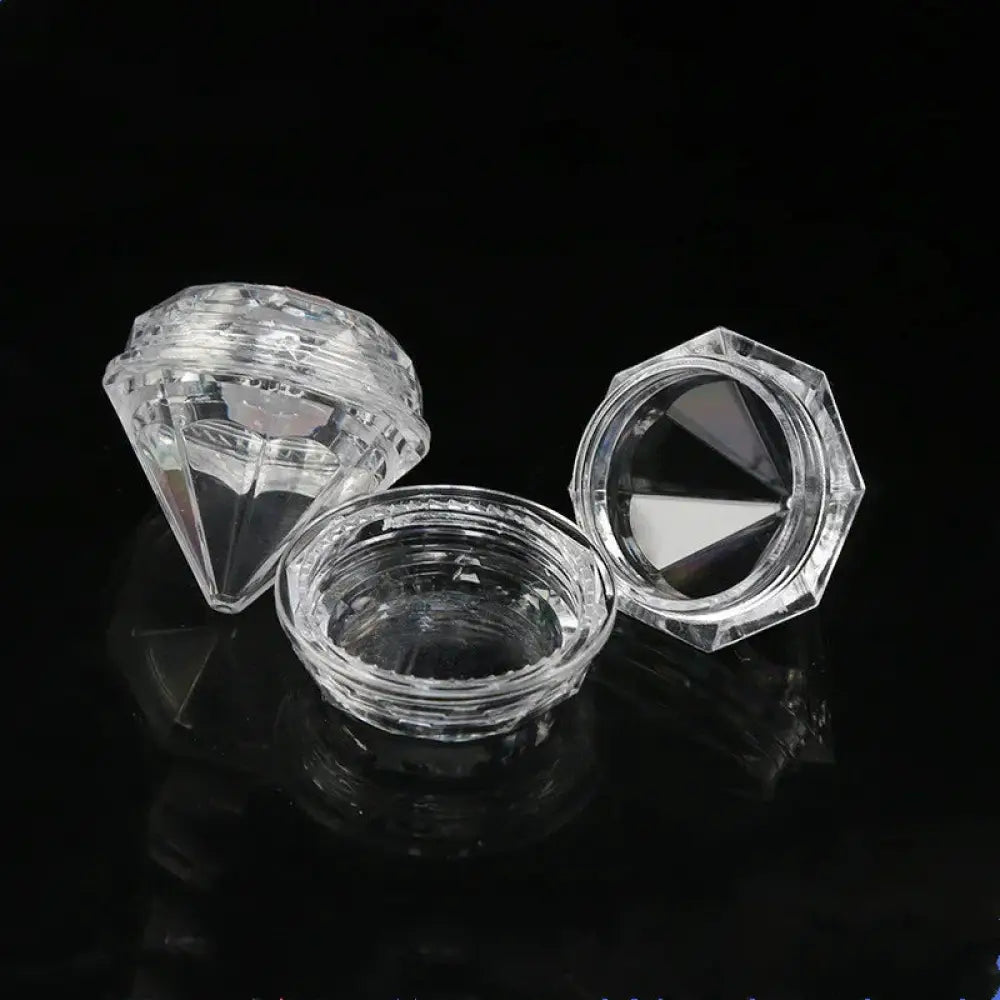 Clear faceted diamond shaped glass travel cosmetic bottles with hexagonal lids and matching bases refillable set
