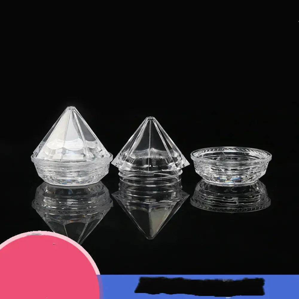 Clear faceted diamond shaped glass refillable travel cosmetic bottles with intricate cut patterns and reflective bases