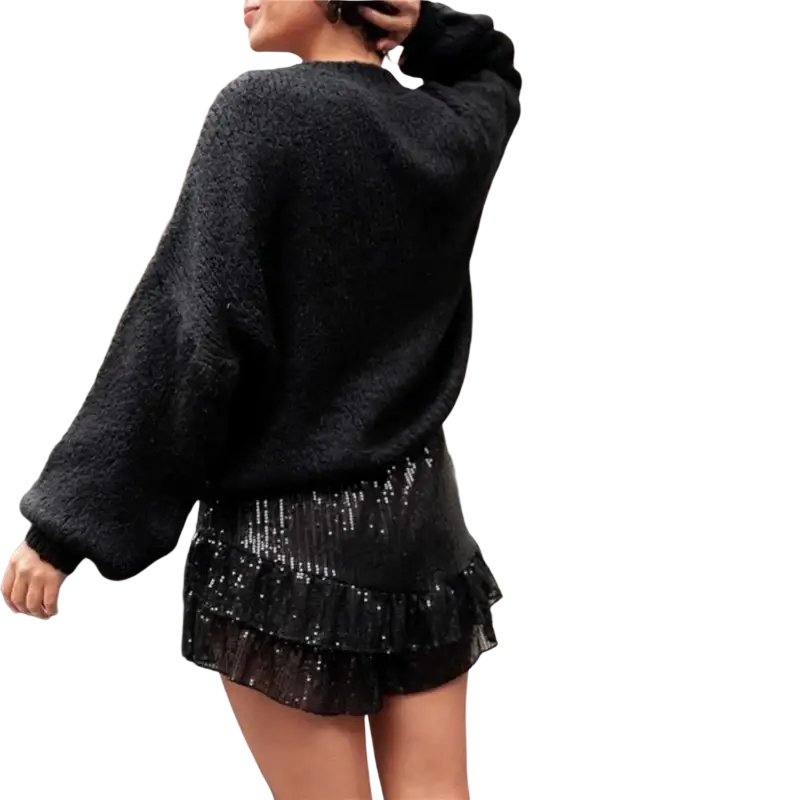 Black sequined ruffle mini skirt with elastic waist featuring a shiny sequin fabric and layered ruffle design