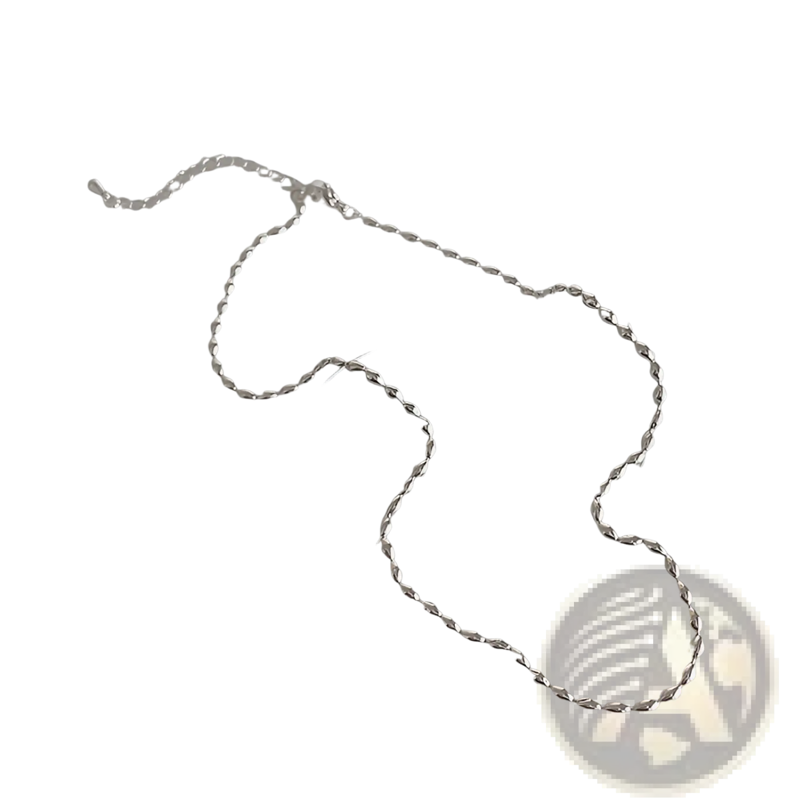 A delicate silver twisted chain necklace displayed on a clear glass dish from a set of five minimalist silver and pearl pendant necklaces