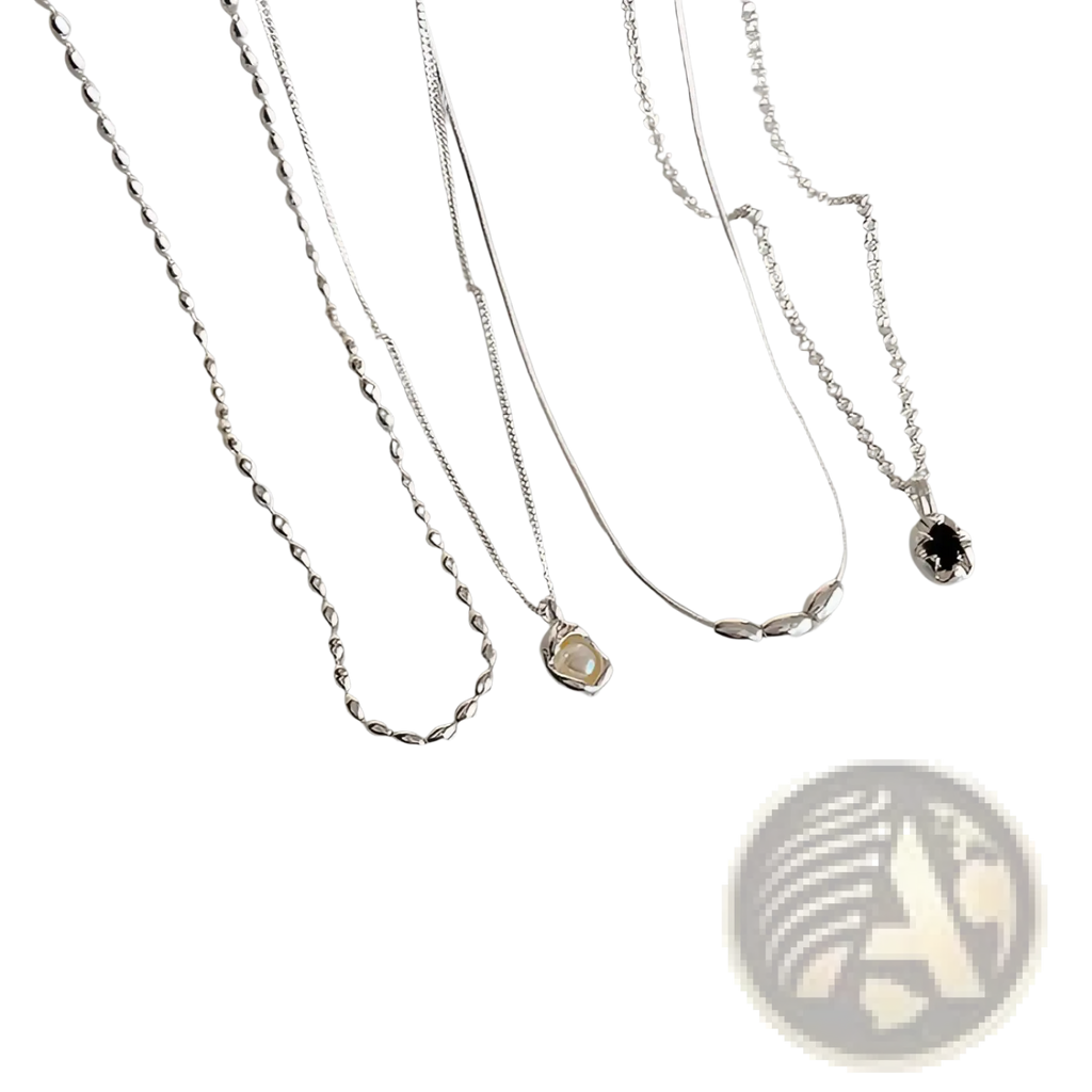 Set of five minimalist silver necklaces with delicate chains and pendants including twisted rope and black gemstone designs