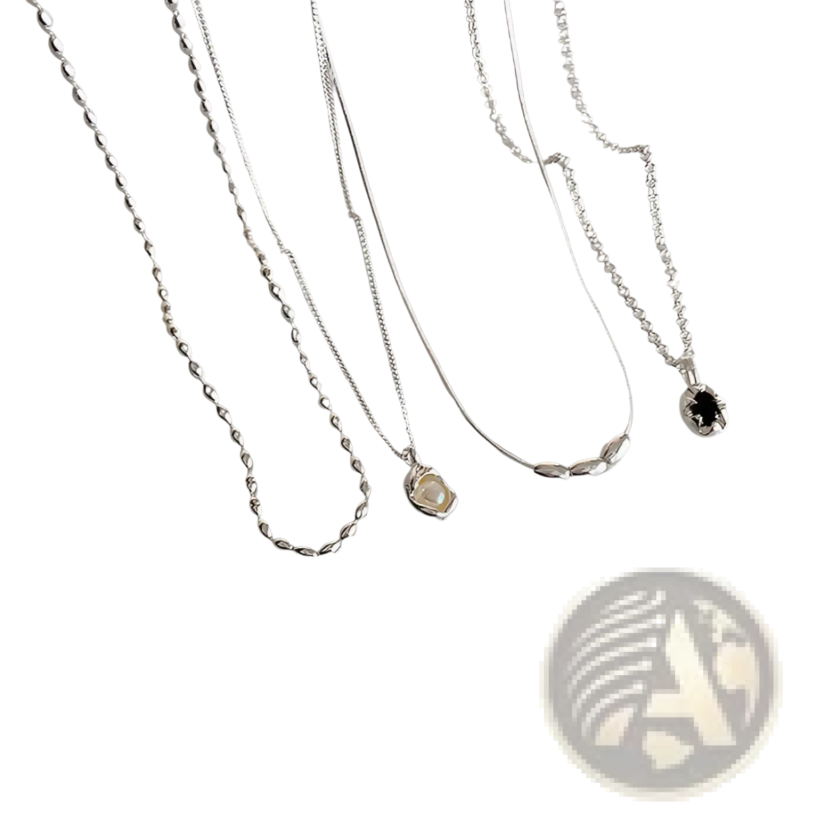 Set of five minimalist silver necklaces with delicate chains and pendants including twisted rope and black gemstone designs
