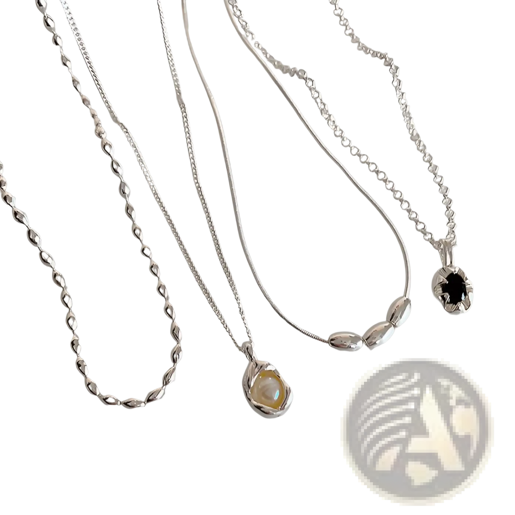Set of five minimalist silver pendant necklaces with delicate chains featuring pearlescent and dark gemstones