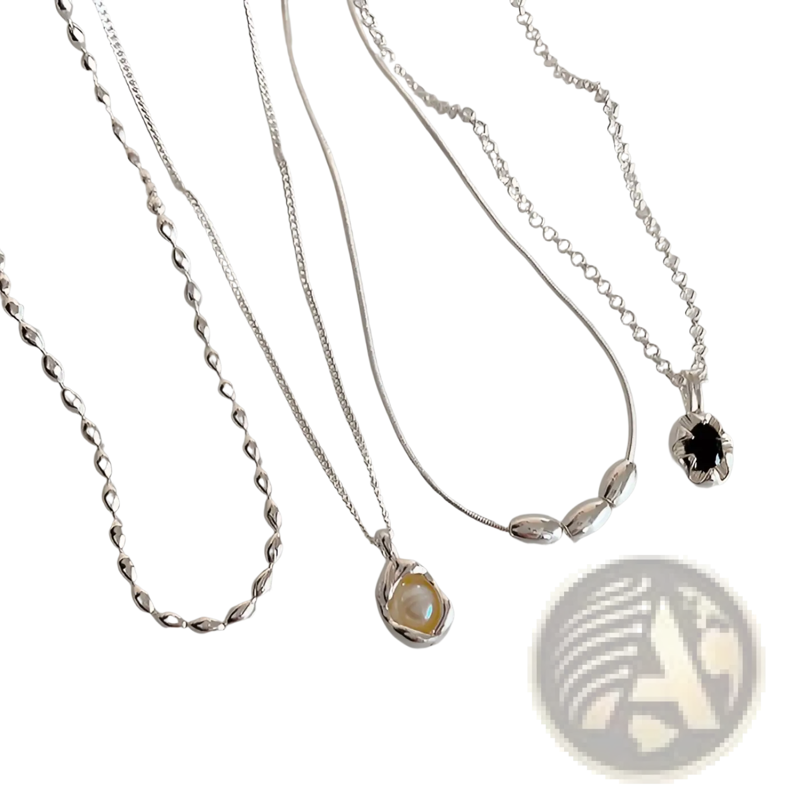 Set of five minimalist silver pendant necklaces with delicate chains featuring pearlescent and dark gemstones