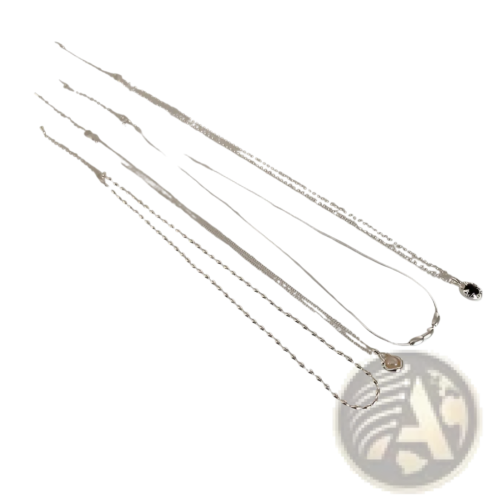 Set of five minimalist silver and pearl pendant necklaces with varying link styles displayed alongside a ruler for scale