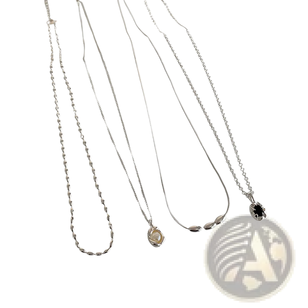 Set of five minimalist silver pendant necklaces with delicate chains featuring pearl, twisted link, bead cluster, and black gemstone designs