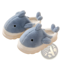 Soft blue plush whale-shaped shark slippers with white cushioned soles and embroidered black eyes for indoor use