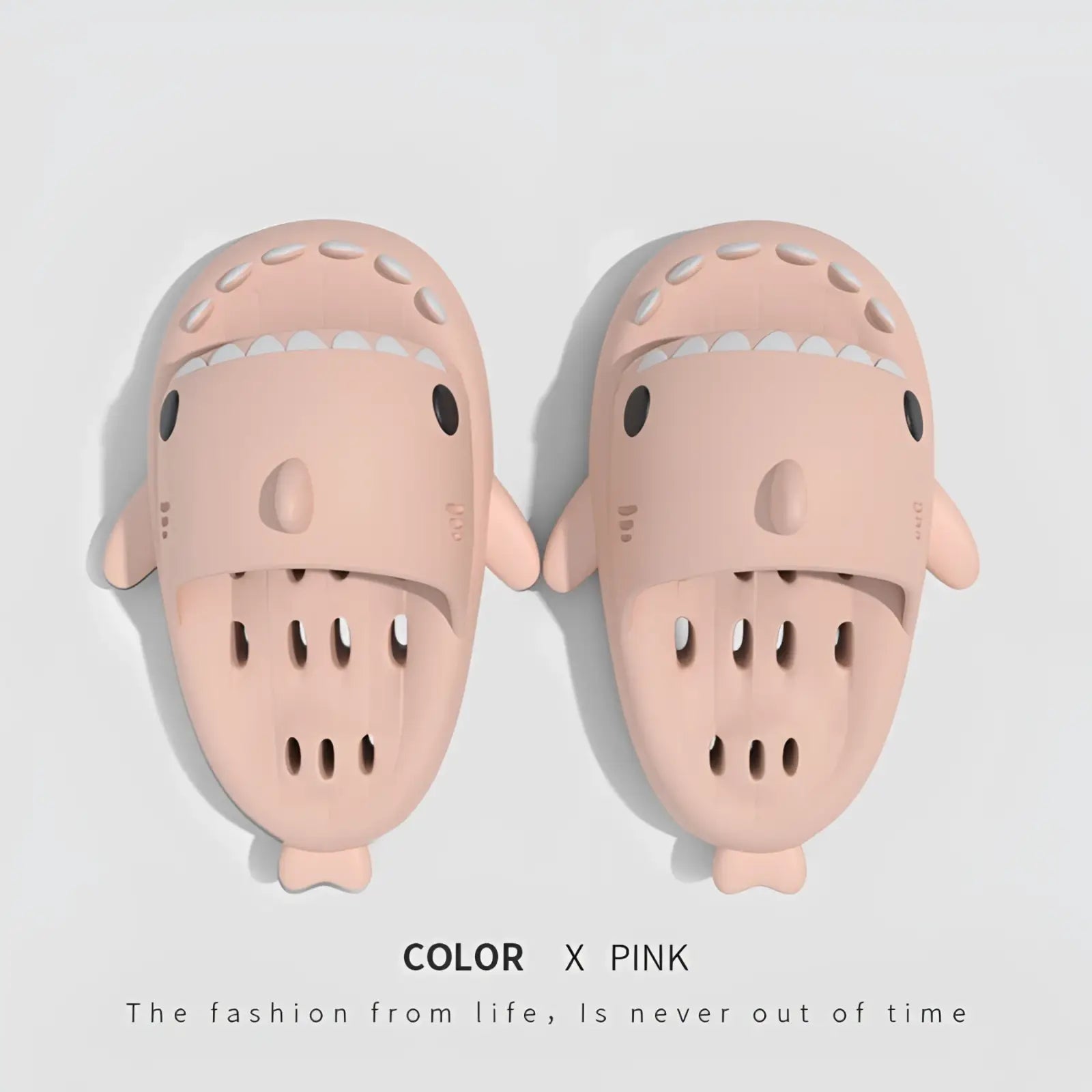 Pink shark-shaped quick dry non slip shower slides made of molded plastic with black eyes and white teeth