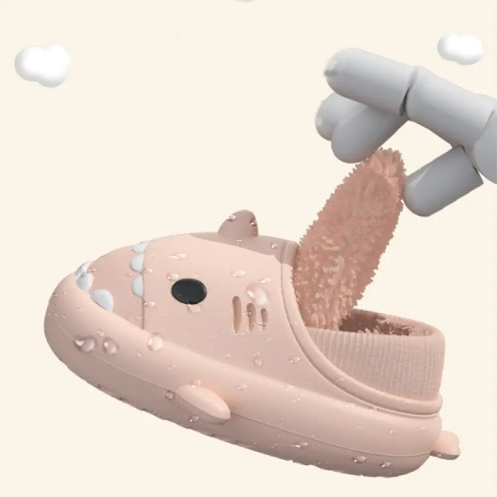 Plush shark winter house slipper in pink with white tooth details and a soft rubber sole with fuzzy interior