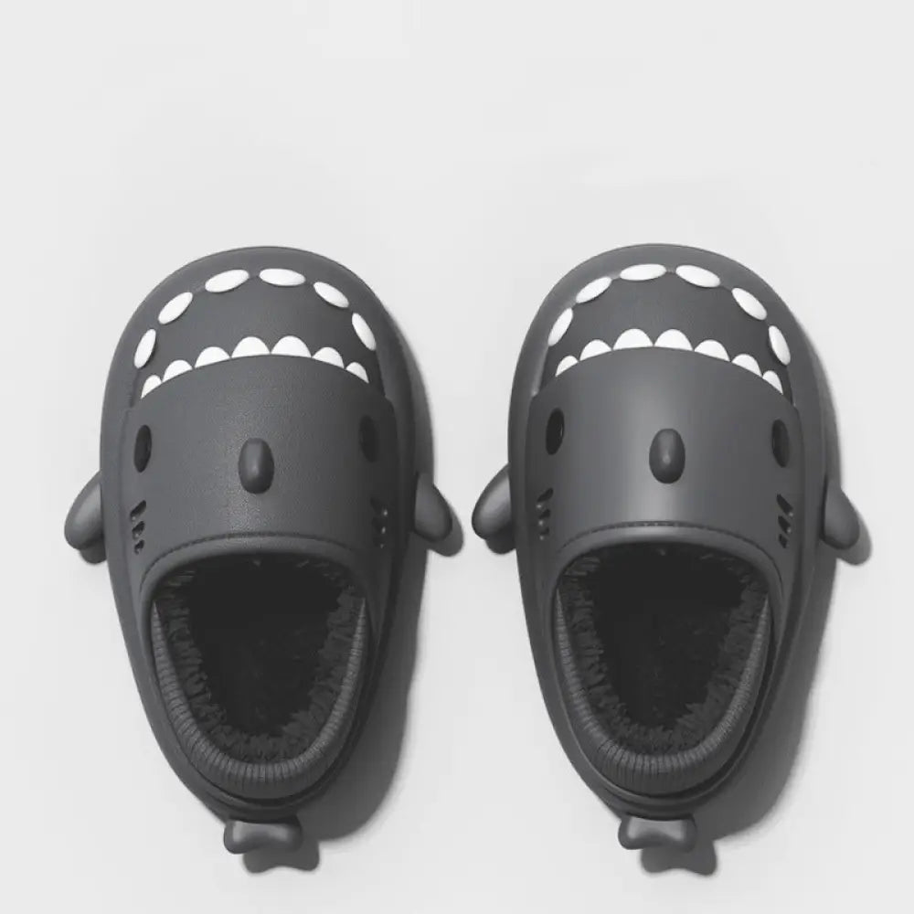 Black shark themed slide sandals with white teeth and small fins featuring soft rubber soles for indoor winter use