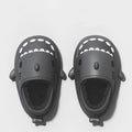 Black shark themed slide sandals with white teeth and small fins featuring soft rubber soles for indoor winter use