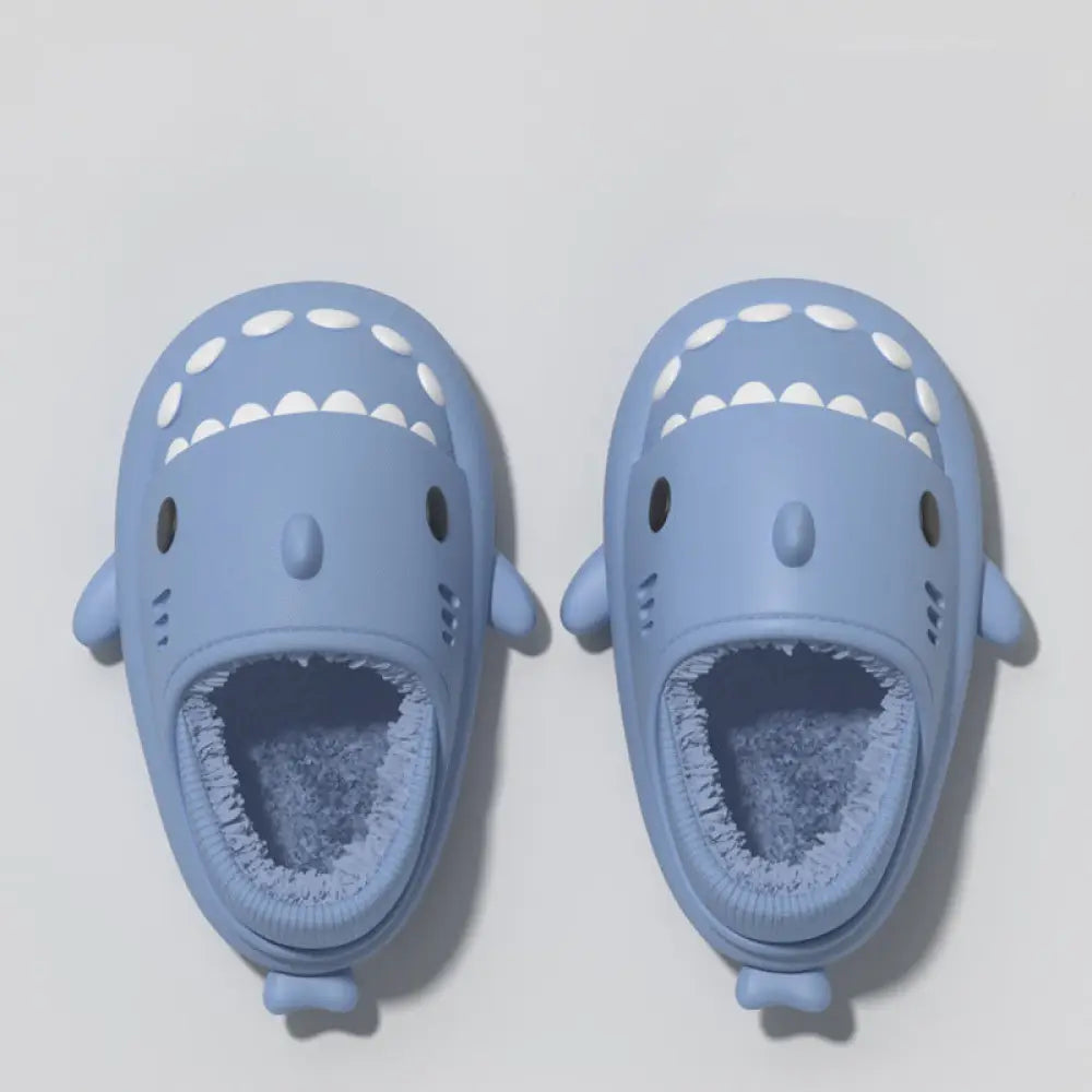 Light blue plush shark winter house slippers with white teeth soft rubber soles and fuzzy interior lining